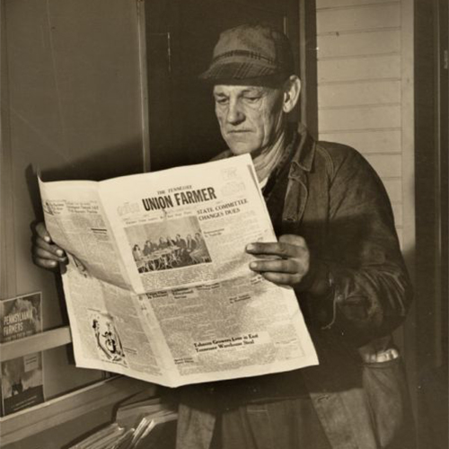 Man reading the Union Farmer, an old newspaper